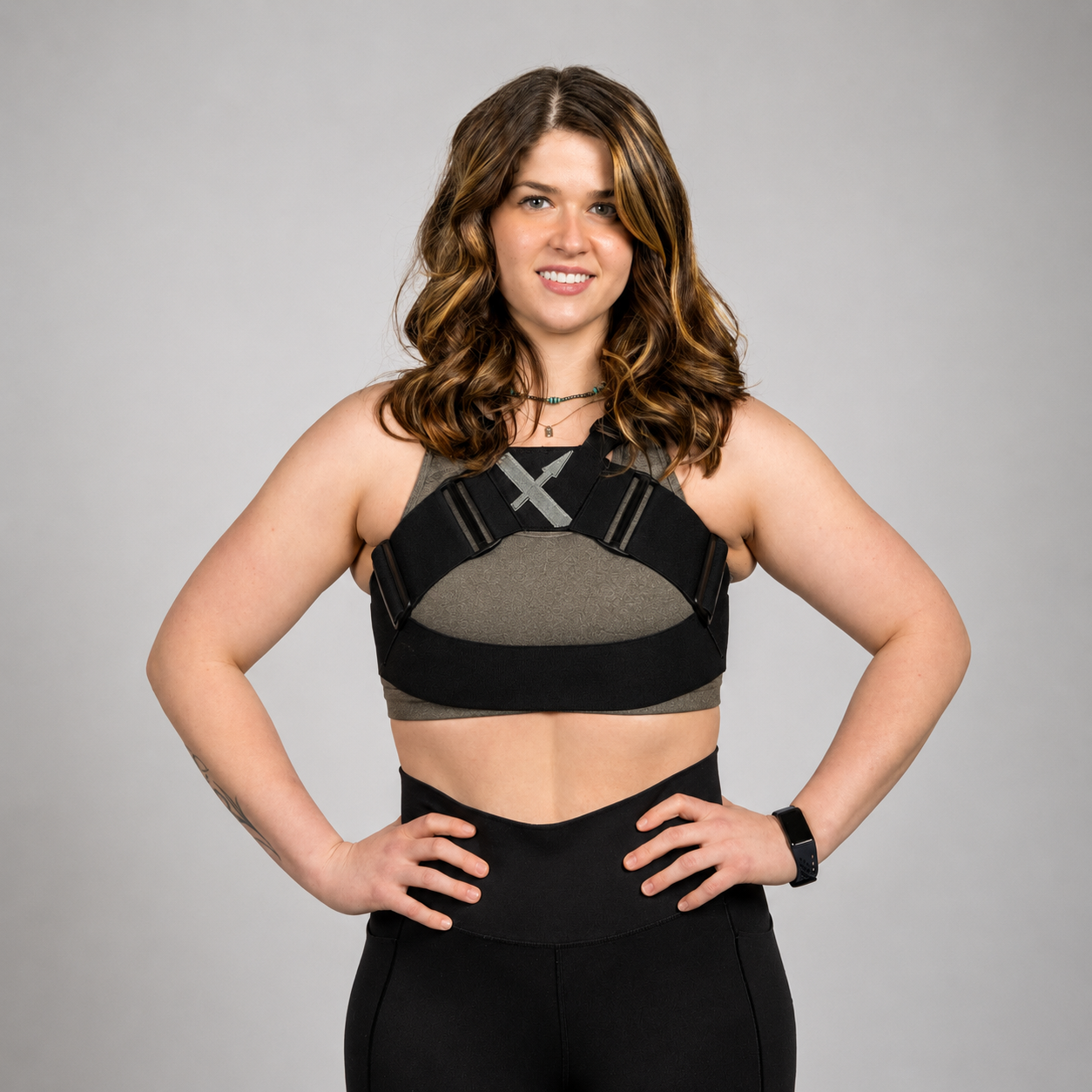 Woman wearing the WRAX Max patented bounce control harness over a sports bra, designed to help women with larger cup sizes reduce breast bounce during running and high-impact workouts.