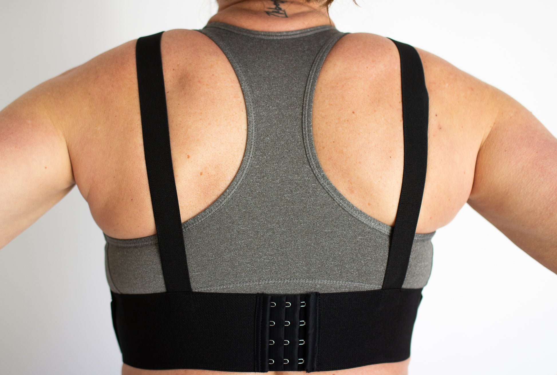 Back view of the WRAX Max bounce control harness featuring a fully adjustable fit system for women seeking better support during running, horseback riding, fitness training, and other high-impact activities.