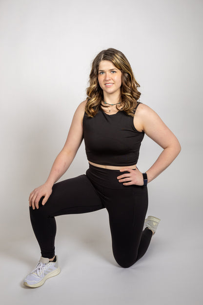 Woman modeling the WRAX Apex sports bra with innovative bounce control technology for running, grappling, boxing, and functional fitness.