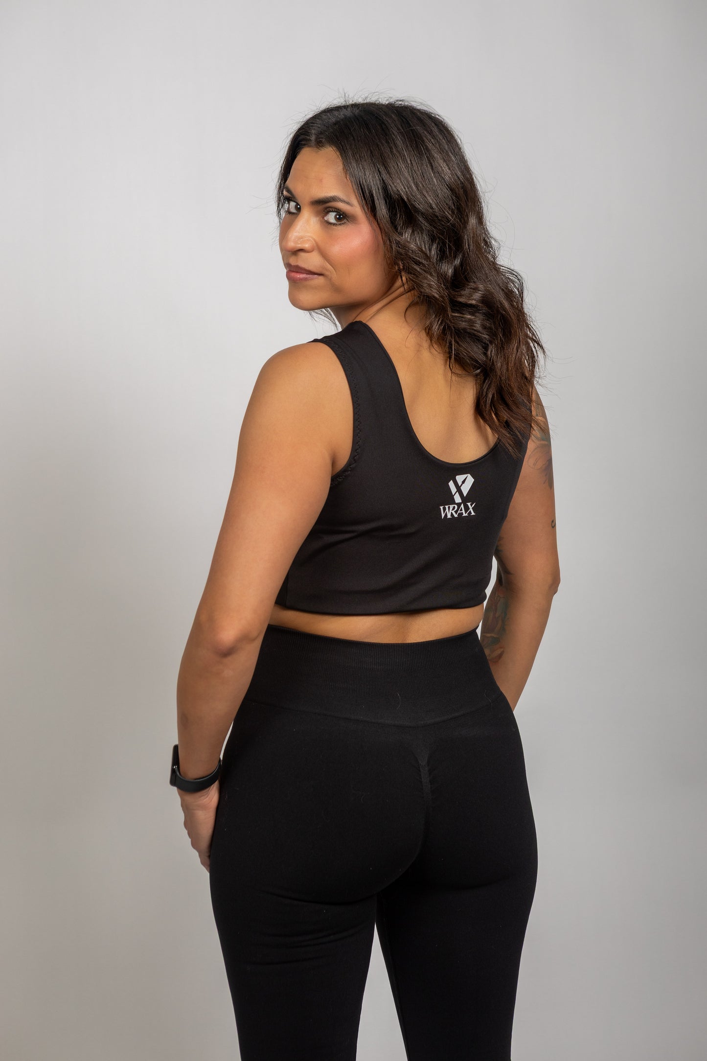 Back view of a woman wearing the WRAX Apex high-support sports bra designed to control breast movement during running, boxing, wrestling, and Jiu-Jitsu.