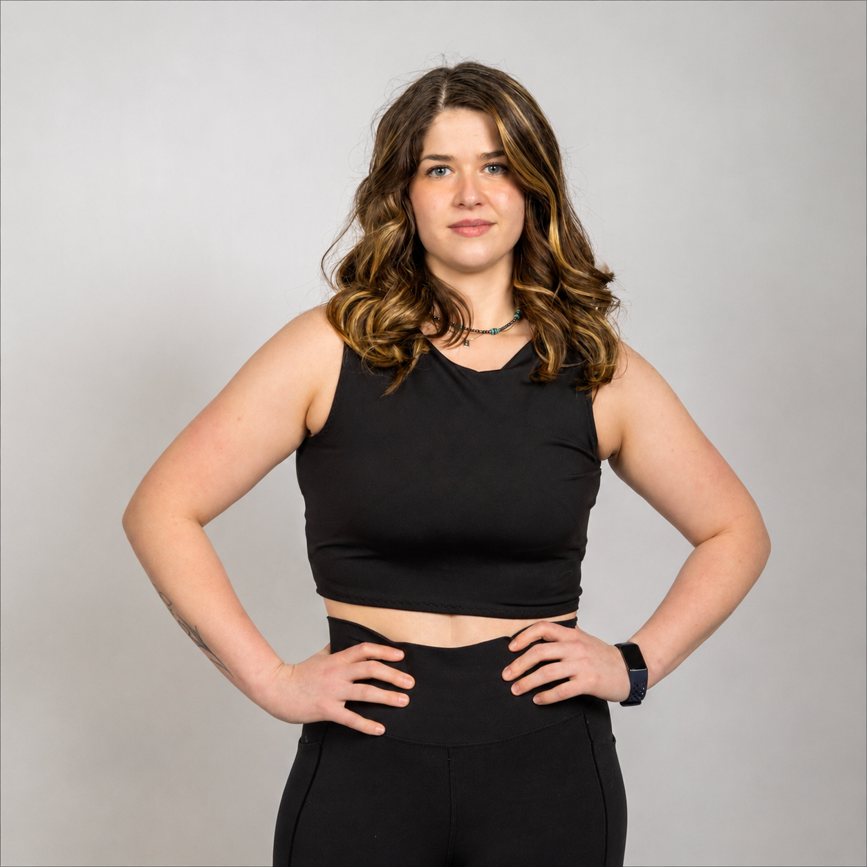 Woman wearing the WRAX Apex high-impact sports bra with patented bounce control technology designed to reduce upward and lateral breast movement during running, HIIT, and combat sports.