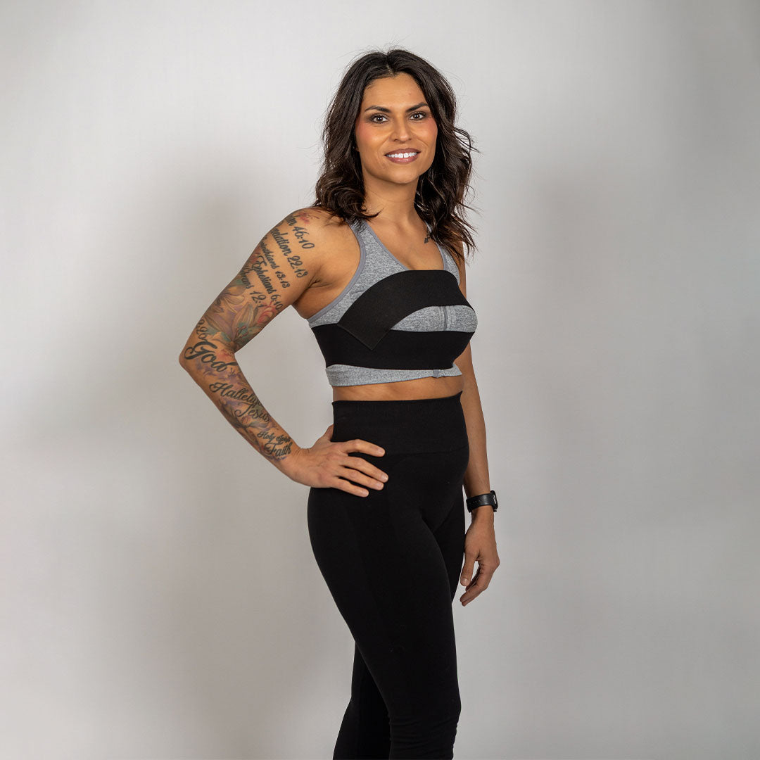 Side view of a woman wearing the WRAX Rebel top-down bounce control harness during high-impact fitness and running.