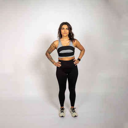 WRAX Rebel bounce control harness worn over a sports bra to help reduce breast movement during HIIT workouts, boxing, and running.